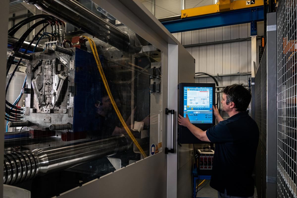 Worker on a Plastic Injection Moulding Machine