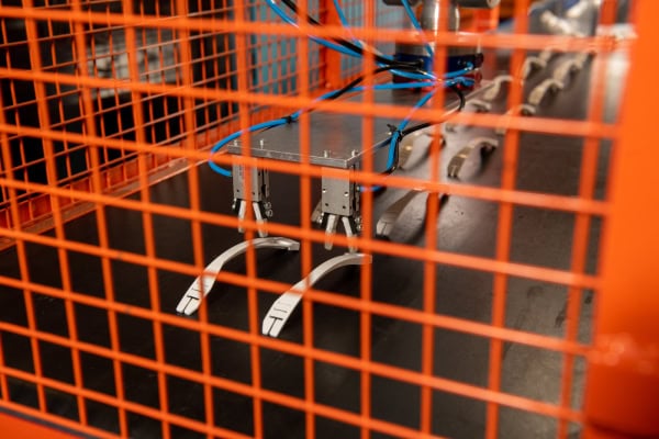 Parts being placed on a conveyer belt after moulding