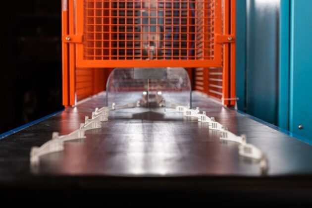 Plastic components on conveyor belt