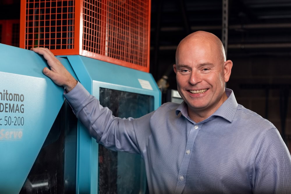 Mark Preston next to injection moulding machine