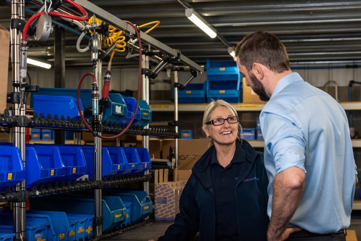 Two employees on product assembly line